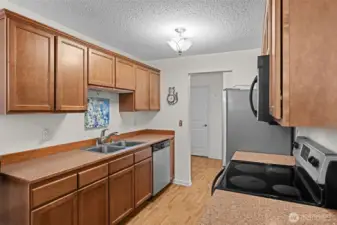 The upgraded kitchen has stainless steel appliances, a luxury laminate floor and plenty of storage and workspace.