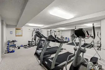 The workout room offers multiple fitness machines.