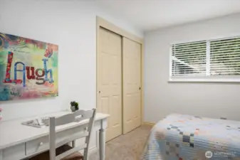 Natural light adorns this guest bedroom and spacious closet (with closet system) is a great amenity!