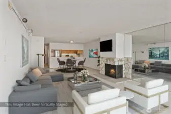 From the vantage point of the living room, the eye is drawn seamlessly into the dining area, where the space opens further into the kitchen beyond—creating a continuous, flowing layout that connects each zone while maintaining its own distinct character.