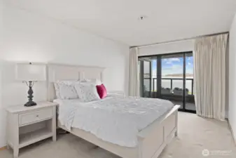 The primary suite features a spacious sliding glass door that seamlessly opens onto the view deck, creating an inviting space to enjoy your morning coffee while basking in the sunrise or to unwind with a refreshing evening beverage as the sun sets.