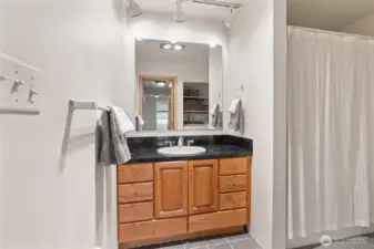 The guest bathroom conveniently includes a full-sized washer and dryer, both just one year old, providing modern functionality without compromising space or style.