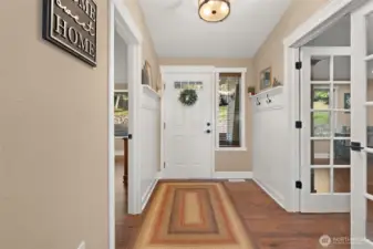 Looking at the front  door with the 3rd bedroom to the left and the large  office/den with french doors to the right.