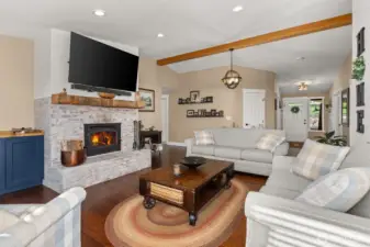 Cozy living area with a wood burning fireplace.