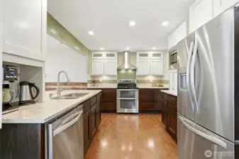 The kitchen has stainless steel appliances and a tile backsplash.