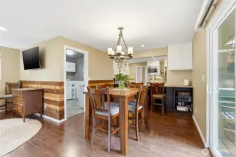 The dining room connects the kitchen and the family room.