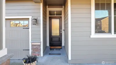 Charming covered front porch with removable wheelchair ramp at the front door—both practical and welcoming for everyday living and guests.