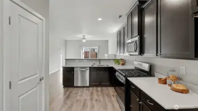 Bright, chef-ready kitchen featuring a large pantry for excellent organization and everyday convenience.