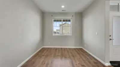 Just inside the front door, the formal dining room sits to the right, offering a welcoming and defined space for hosting and special occasions.