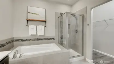 Beautifully designed tile shower with elegant finishes, adding both style and comfort to the primary suite.  Huge walk in closet with ample storage.