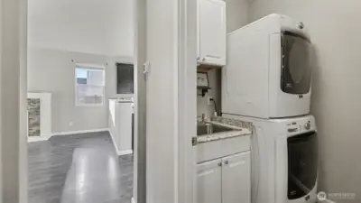 Convenient laundry room with utility sink; washer and dryer included for added ease and functionality.