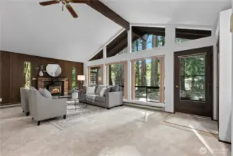 Light-filled living room with soaring ceilings and expansive windows.