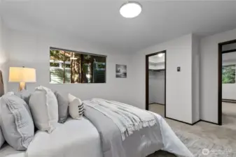 Spacious primary bedroom with peaceful outlook.