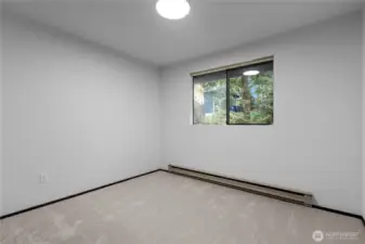 Secondary bedroom with natural light and simple finishes.