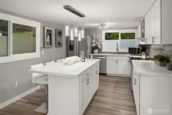 Beautifully updated kitchen with large gathering island, quartz counters and stainless appliances.