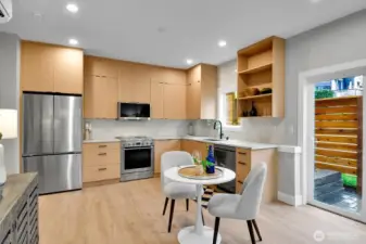 Great natural light with large windows and sliding glass door to fenced patio area