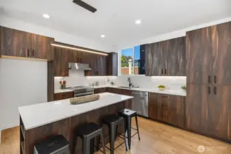 Full height quartz backsplash, under cabinet lighting.