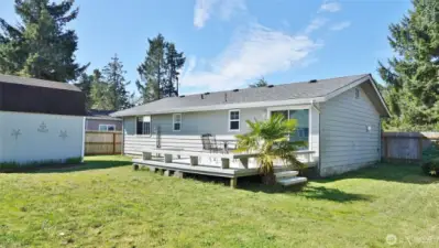 Rear view of the home w/ Deck, Shed and Fenced Backyard.
