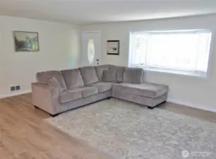 Entry and Living Room w/ a classic bay window.