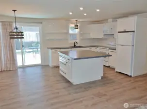 Dining Area and Kitchen w/ Slider to the Rear Deck and Fenced Backyard.