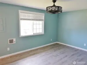 Master Bedroom w/ LVP flooring and a view out to the backyard.