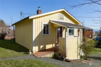 Cabin offers easy access with a ramp - just up from driveway. Surrounded by healthy green grass and shrubbery, this little cabin is just waiting to "wow!" you!