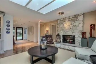 This angle shows the entry and includes the wood-burning fireplace. Seller has installed electric logs.