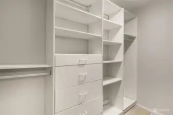 Walk in closet with custom cabinetry