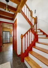Stairway to second floor, looking E into kitchen.