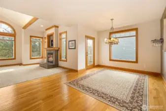 Dining area, door to deck and living room w/ fireplace.