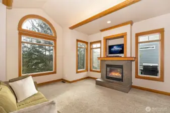 Comfortable size living room w/ wood burning fireplace & vaulted ceilings.