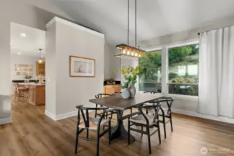 Dining area off of the kitchen with adjoining living space.