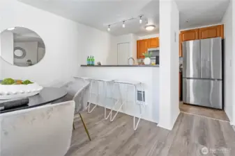 Another view from the dining room to the open kitchen. Pull up stools to the breakfast bar for a quick meal.