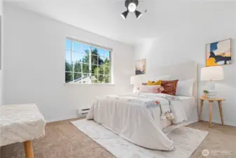 The guest bedroom is also generously sized and receives warm afternoon sunlight with western views.