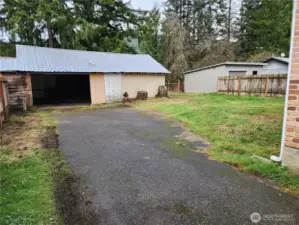 Driveway view of backyard