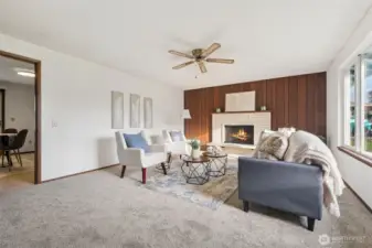 As you enter the house to the right is this very generous living room with unique brick work, wood burning fireplace.