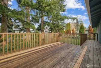 Here's the roomy deck with stairs to the bottom of this photo. Seller has replaced some of the boards that were starting to show wear.