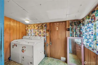 Side entry leads to a functional utility mud room.