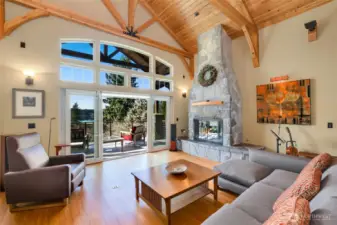 Large stone fireplace, wall of sliders out to the large deck