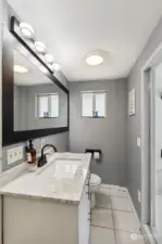 Off the Pool is this Convenient Bath w/Tile Floors, Vanity w/Granite Counter, Oversized Mirror and New Light Fixture. Separate Tub and Shower.