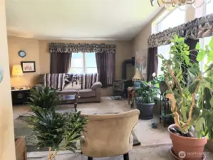 Another Picture of the Enormous Living Room with an Economical Free Standing Gas Stove to Heat the Whole Home From the Dining Room Area.