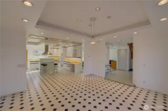 Main floor dining room looking into the kitchen and entry.