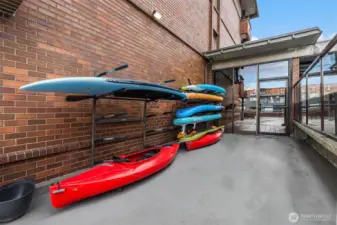 Common storage for water craft next to pool. You can see through door to the Unit's parking area. Super convenient access.