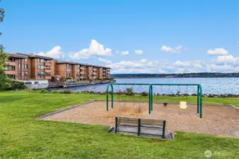 Madison Park North Beach playground near South side of Building A looking East across the Lake. Bus Stop on other side of 43rd Ave E for Route 11.