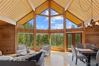 A timeless wall of wood-wrapped windows pairs beautifully with exposed beams and tongue-and-groove ceilings.