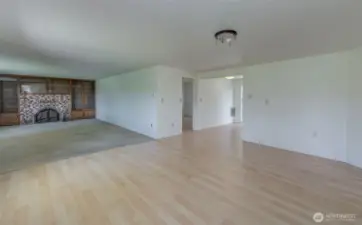 Large, bright living room with fireplace and wall-to-wall custom storage