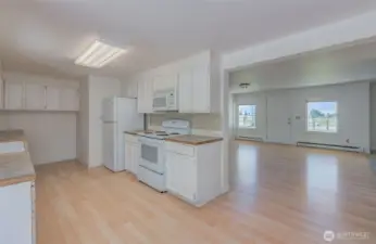 Standing in a small breakfast area looking toward kitchen and dining room