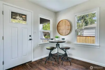 A cheerful entry leads to a bright dining nook framed by sunny windows, with open sightlines to the kitchen and living room—perfect for gatherings and everyday ease. There is all new baseboard trim throughout the main floor.