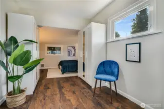Room to relax, space to store—this inviting primary suite includes a sitting area or office space, closet cabinetry, and durable flooring that’s ready for everyday living.