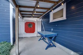 This quaint covered patio offers a perfect spot to enjoy coffee or meals outdoors—even on rainy Pacific Northwest days.